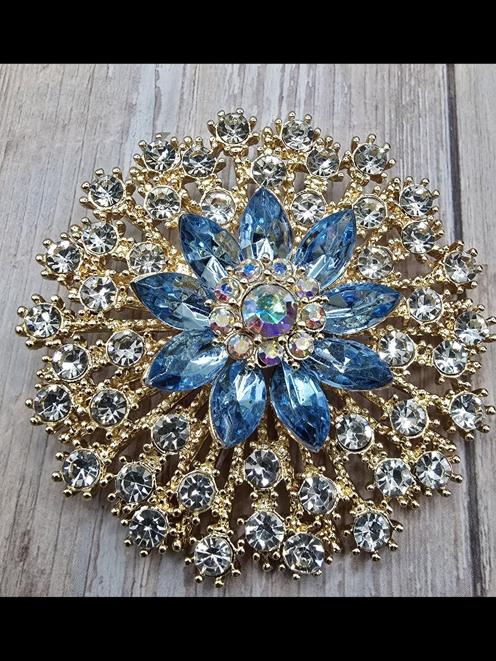 Gold Floral Brooch with Blue Crystal Petals